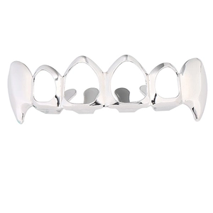 Detailed macro view of silver hollow fangs grillz with polished six-tooth design