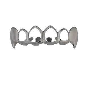 Macro view of silver hollow vampire fangs grillz with six open face hip hop teeth