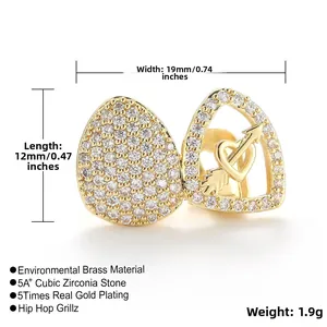 Macro shot of gold plated hip hop grillz with cubic zirconia and heart arrow cutout
