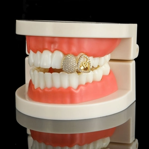 Iced out gold grillz set with arrow heart and oval cubic zirconia pavé on teeth