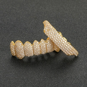 Hip hop gold plated grillz set with micro-paved cubic zirconia stones on black background