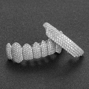 Hip hop silver grillz set with micro-paved cubic zirconia stones on black background