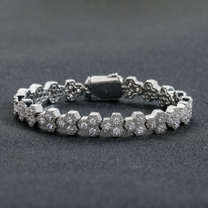 Detail of silver floral link bracelet with shimmering zircon stones and secure clasp