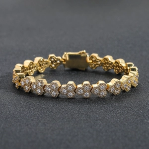 Macro shot of gold-plated heart-link tennis bracelet with cubic zirconia inlays