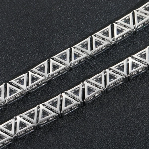 Macro shot of silver tennis necklace with 9mm triangle-cut cubic zirconia inlays