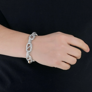 Detailed view of silver link bracelet with iced out cubic zirconia stones on wrist
