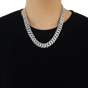 Close-up of 15mm iced out silver Cuban link chain with T-square zircons on a model