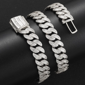 Macro shot of 15mm silver Cuban link chain with baguette and pavé-set crystals