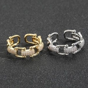 Macro shot of U-shaped buckle rings in gold and silver with micro-paved cubic zirconia