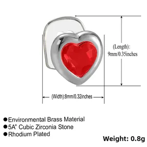 Detail view of heart-shaped brass tooth grill with red zircon inlay and 9x8mm dimensions