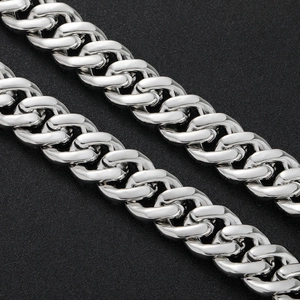Macro detail of high-polish silver cuban link chain with bubble square zircon stones