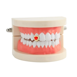 Hip hop style gold grillz featuring a red heart gemstone for dental decoration
