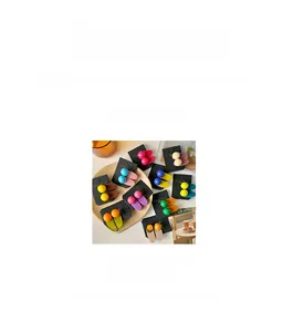 Detail shot of colorful candy-colored hair clips with sphere charms and measurements