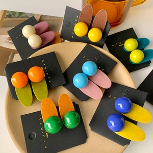 Colorful candy-colored hair clips set on a display card for autumn hair styling