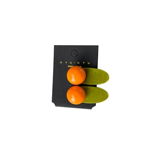 Vibrant orange and olive green candy color hair clip on a minimalist display card