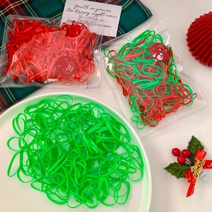 Christmas themed red and green elastic hair bands in festive gift packaging with stickers
