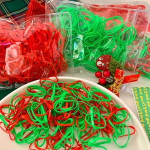 Christmas themed high elastic hair bands in red and green colors with festive gift packaging