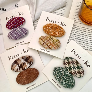 Set of oval vintage wool fabric hair clips with tweed patterns in warm autumn colors