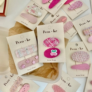 Pink woven heart and cherry hair clip set for kids with tweed and knit textures