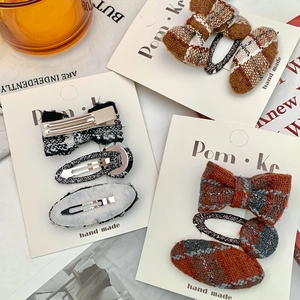 Retro plaid bow hair clips set for girls in warm orange and black tweed fabric textures
