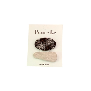 Set of two fabric hair clips featuring brown plaid and cream knit textures for girls