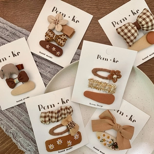 Handmade brown and beige floral bow hair clips set for girls on card display