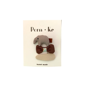3-pack brown fabric bow and elephant hair clips for girls on white card packaging