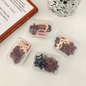 Matte finish hair clips set in earthy tones including star and bow shapes in gift boxes