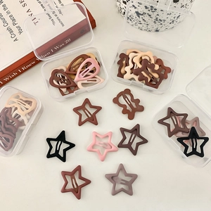 Matte hair clips set with star and heart shapes in cream tones with storage box