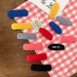 Colorful fleece plush oval BB hair clips set for women on a cozy decorative background