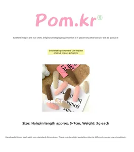 Detailed view of soft teardrop-shaped faux fur hair clips in warm pastel colors