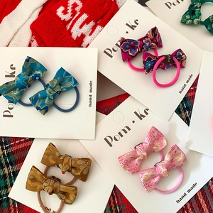 Pairs of Chinese style bow hair clips with traditional floral brocade fabric and gold patterns