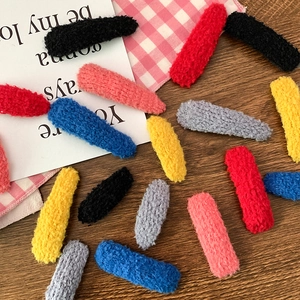 Plush lamb wool colorful oval hair clips set in various sweet colors on a wooden table