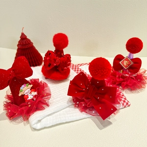 Festive red velvet hair clips with glowing bows and New Year themed decorations