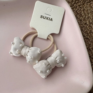 Elegant pair of cream satin bow hair ties with hand-sewn pearls for girls