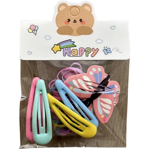 Colorful kids hair accessory set with metal clips and elastic bands on wooden background