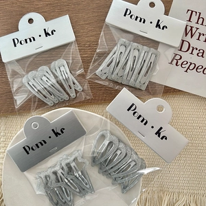 Glittery silver star and drop hair clips set for girls in elegant card packaging