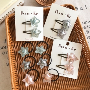 Cute star-shaped glitter hair clips and elastic hair bands for girls on display card