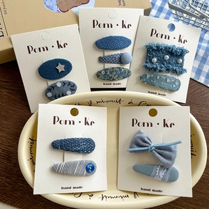 5-piece blue lace bow hair clip set with denim patterns and pearl accents on display
