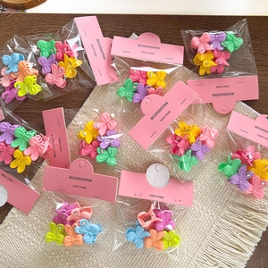 Macaron butterfly hair clips set with cute handmade packaging on white woven mat