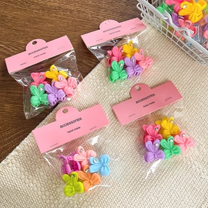 Bow-shaped matte hair clips with star details in assorted pastel colors for girls