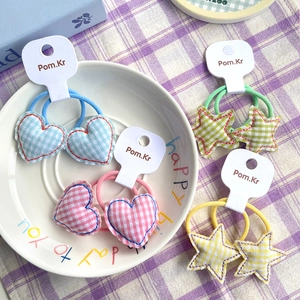 Cute heart and star gingham hair ties for girls on a decorative ceramic plate