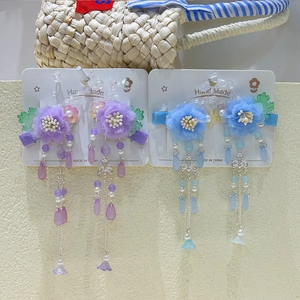 Detail of handmade Hanfu flower hair clips with purple tassels and pearly beads