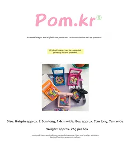 Detailed size chart for mini bone and star shaped pet hair clips in storage box