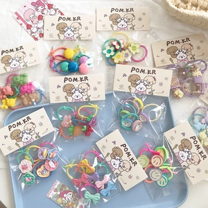 Detail of colorful macaron children hair ties with bows and smiling bear charms