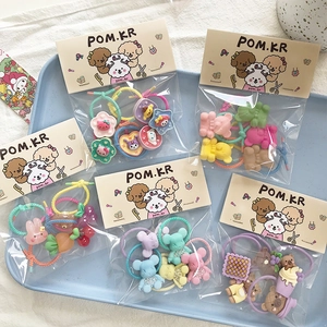 Close-up of colorful kids hair ties set featuring cartoon bear and rabbit charms