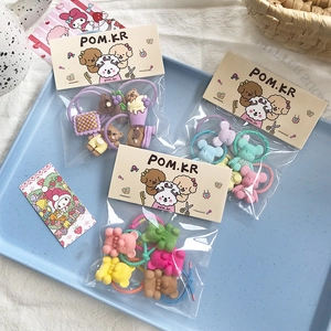 Detail view of colorful children hair ties set with resin cartoon bear and flower charms