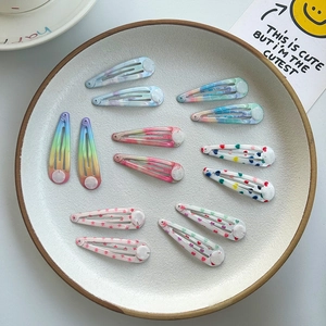 Colorful 12-piece set of cartoon print snap hair clips with rainbow and heart patterns