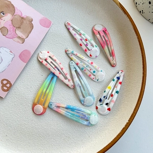 Detail view of 7-piece colorful teardrop hair clips with heart and star patterns