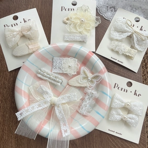 Elegant lace bow and pearl hair clips set for girls featuring floral and butterfly designs